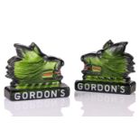 A pair of mid-20th century Gordon's gin green glass advertising signs, modelled as the head of a