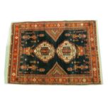 A 20th-century indigo blue ground Afshar rug with two lozenges and hanging motifs, within multiple