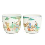 A pair of Chinese porcelain boys cups, painted in a famille rose palette, with boys holding
