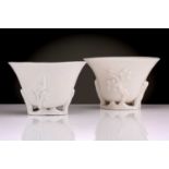 Two Chinese Dehua blanc de chine libation cups, Qing dynasty, 18th century, each with applied
