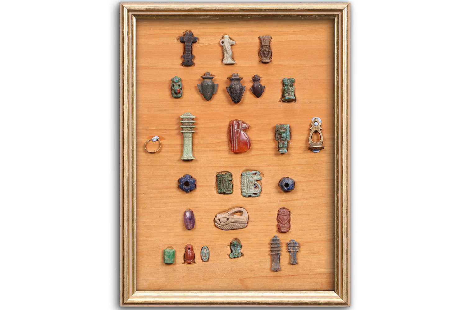 A Collection of Ancient Egyptian artefacts including a bronze Djed pillar amulet, agate Tawaret