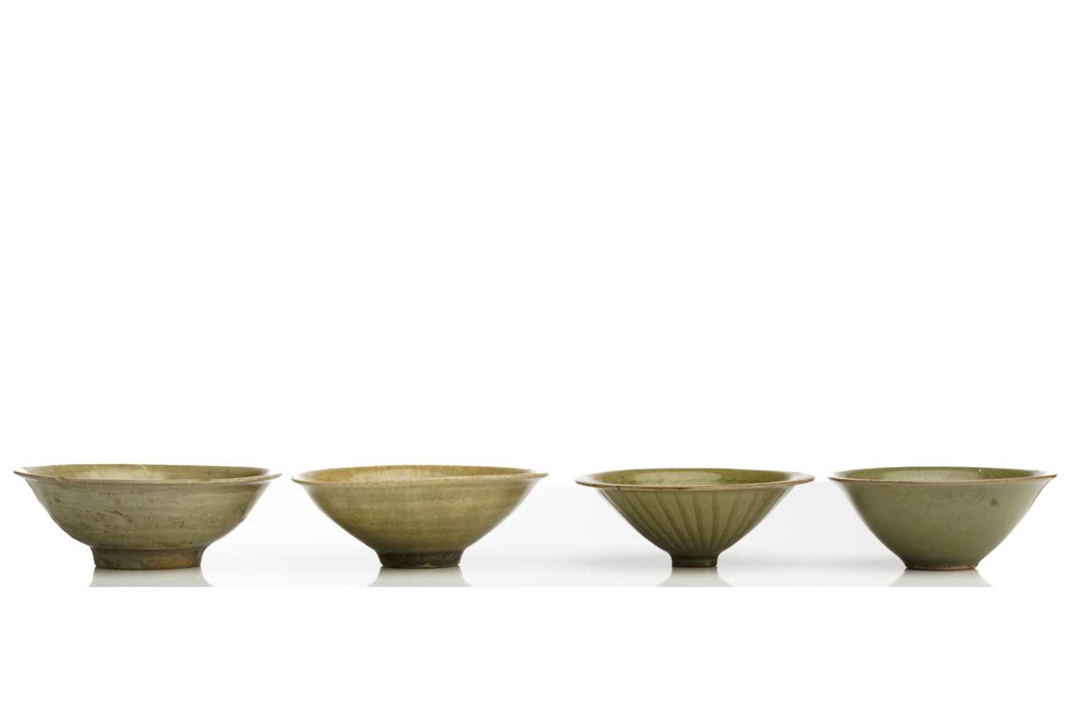 A Chinese Longquan celadon bowl, Song - Yuan dynasty, of shallow conical form, with flower head