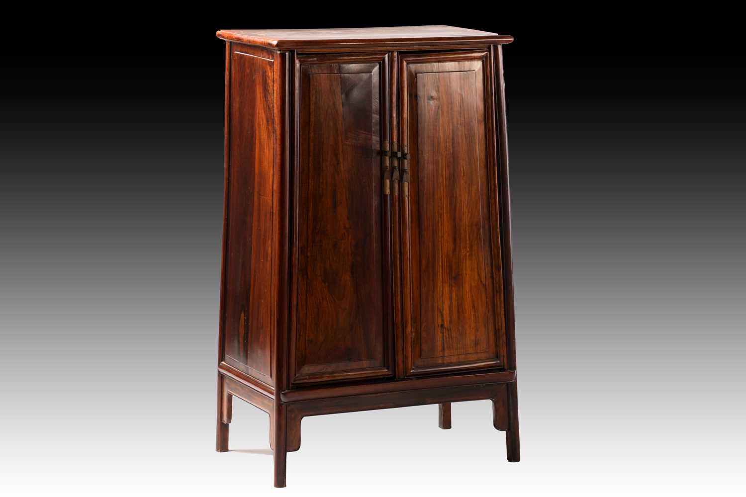 A Chinese Huanghuali tapering two-door cabinet with radiused corners, Qing Dynasty. Each door with