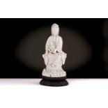 A Chinese Dehua blanc de chine figure of Guanyin, Qing dynasty, Kangxi,17th century, seated in