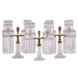 A Regency garniture of three cut glass lustre and ormolu two sconce candelabra with fine diamond cut