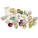 A collection of Halcyon Days hard enamelled patch boxes and eggs to include Her Majesty Queen