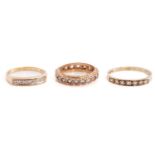 Two diamond half eternity rings in 9ct gold and an eternity ring; the first half eternity ring has