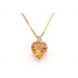 A topaz and diamond pendant on chain, comprises a heart-shaped yellow topaz of 11.3 x 10.6, in a