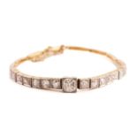 An Art Deco style diamond line bracelet, featuring fifteen graduated old-cut diamonds accented