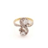 A diamond Toi et Moi ring, of a twisted 'S' form, set with two larger old-European cut diamonds