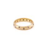 A diamond etoile band ring in 18ct yellow gold, flush set with sixteen brilliant-cut diamonds in the