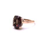 A highly prized collectors colour-changing garnet ring, featuring an oval-shaped garnet displaying
