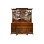 A large early 19th century figured mahogany break-front secretaire library bookcase; the upper