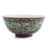A Chinese porcelain dragon bowl, painted with three dragons chasing a pearl through fiery clouds