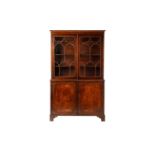 A George III and later mahogany bookcase cabinet, the moulded cornice above a pair of glazed doors