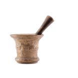 A bronze pestle and mortar, the mortar with collared tapering sides, 15 cm high 17.5 cm diameter,