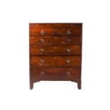 A large George III mahogany chest of two short over four long drawers with simple ebony and