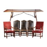 A large 19th-century Spanish walnut refectory table and a matched set of eight French Louis XIV-