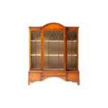 An early 20th-century mahogany miniature single-door breakfront bookcase with a domed central