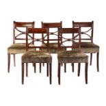 A set of six Regency mahogany dining chairs, the tablet and cross frame backs above stuff-over seats
