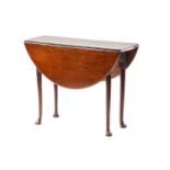 A George III mahogany drop leaf table, the oval top on turned tapering legs with club feet, 92 cm