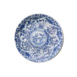 A Chinese blue & white charger, Qing, Kangxi period, the centre painted with flowers within a