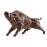 A Chinese bronze figure of a boar, standing on all fours sniffing the air, traces of gilt and red