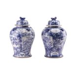A pair of large Chinese style porcelain vases and covers, the covers with stylised shi shi knops,