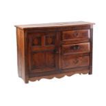 An 18th century and later oak and elm dresser with a planked top above a bank of three short drawers