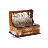 A Victorian walnut and gilt-metal mounted three decanter tantalus and games compendium, the square