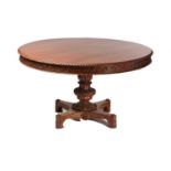 An Anglo-Indian padauk wood circular centre table, late 19th/early 20th century, with moulded rim