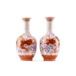 A pair of Chinese porcelain dragon vases, the red dragon highlighted with gilding chasing a