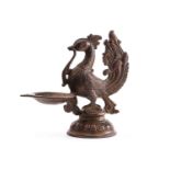 A Chinese bronze model of a South Indian peacock oil lamp, standing on a circular lotus base, traces