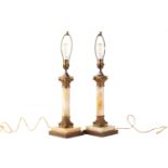 A pair of 'Hollywood Regency' gilt metal and onyx Corinthian column table lamps on stepped