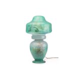 A Monart table lamp and shade, of mushroom form in mottled green glass, in two pieces, the base of