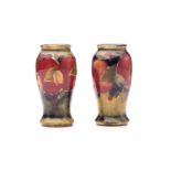 A pair of William Moorcroft miniature 'Pomegranate' baluster vases, both signed in green W M, one