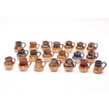 Twenty Doulton stoneware miniature harvest jugs, twelve of them having silver rims, largest 4.5cm