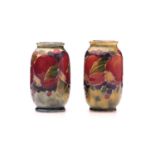 A pair of William Moorcroft miniature 'Pomegranate' on ochre ground vases, signed W M, circa 1910,