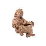 A very large Bretby cream glazed art pottery figure of a seated Gypsy girl with a bow in her hair