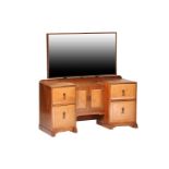 Cotswold school, a walnut and sycamore mirror-backed dressing table in the manner of Oliver Morrell,