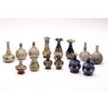 A collection of fourteen Doulton stoneware miniature vases, jug and pepperette, largest 10.5cm