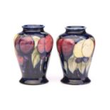A pair of Moorcroft 'Wisteria' pattern baluster vases, circa 1920, with impressed marks Moorcroft