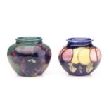 Two Moorcroft small bulbous vases, 'Wisteria' and 'Purple Orchid patterns, one with 'By