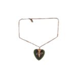 A Nephrite heart shape pendant measuring 39x39mm on yellow metal stamped 9ct on base metal chain.