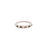 An emerald and diamond half eternity ring in 18ct white gold, comprises five round brilliant-cut