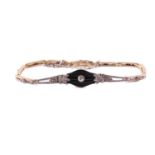 An onyx and diamond bracelet, comprising a grooved baluster-shaped panel, with an old-European cut