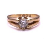 An Edwardian single stone diamond ring; pierced bifurcated shoulders terminating in six rounded claw