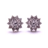 A pair of diamond cluster stud earrings, each comprising an old-cut diamond at the centre in an