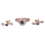A Sapphire and Diamond cluster ring and earring set, the ring is formed from a central claw set