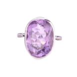 An amethyst dress ring in 18ct white gold, comprising an oval-cut amethyst in tube collet,